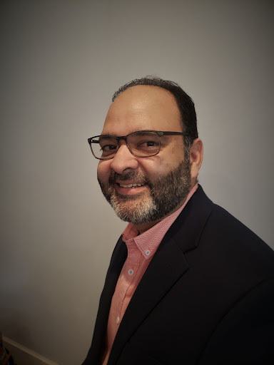 UMD graduate Abrar Ansari posing for a professional headshot