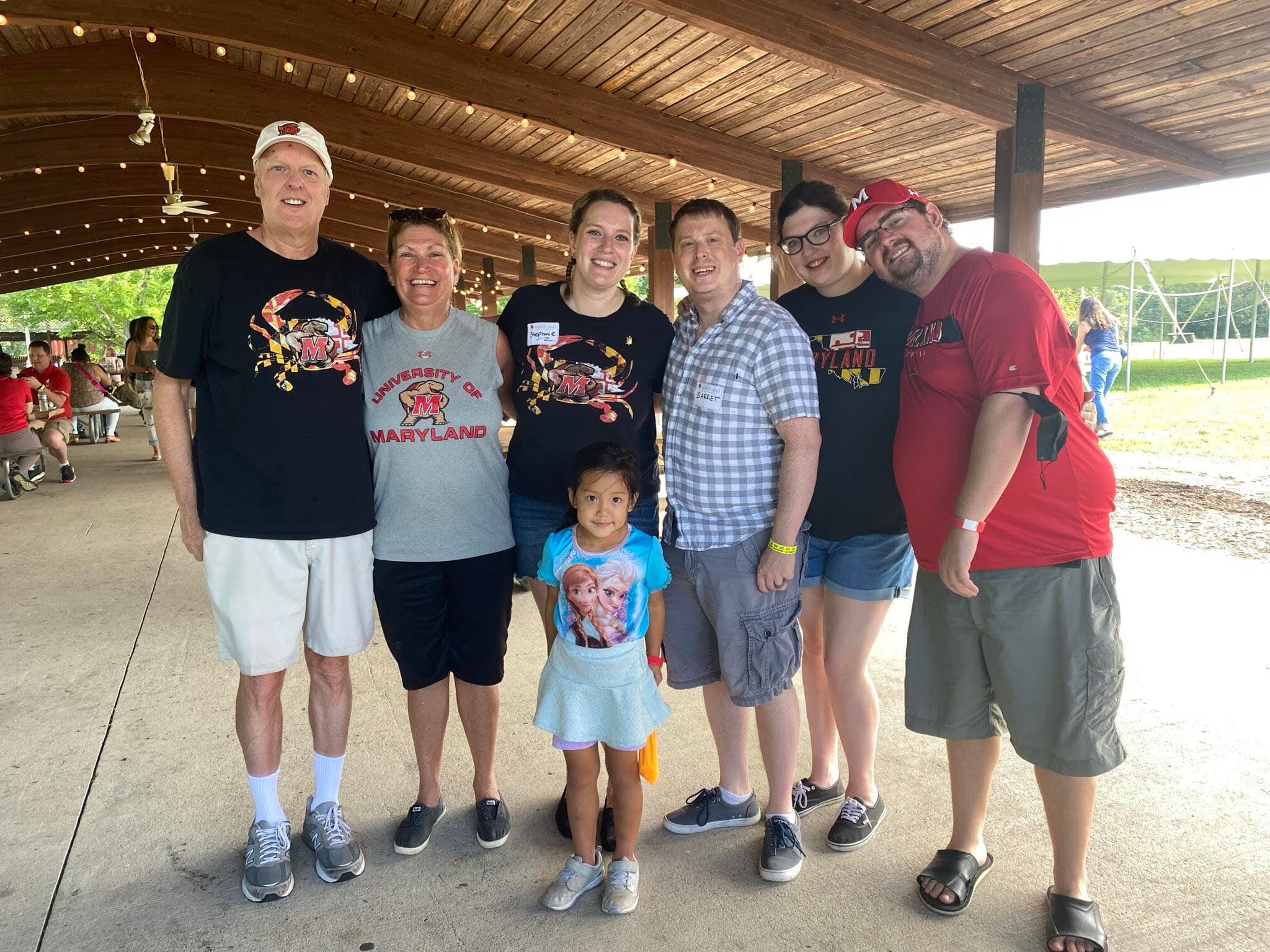 (Left to right) Mark Groff, Julie Groff '83, Stephanie Groff '13, Barrett Claunch (Stephanie's husband), Hayley Groff '16, Steve Bernard (Hayley's partner) and family friend Geneva Chang (front) at a 2021 MoCo Terps crab feast