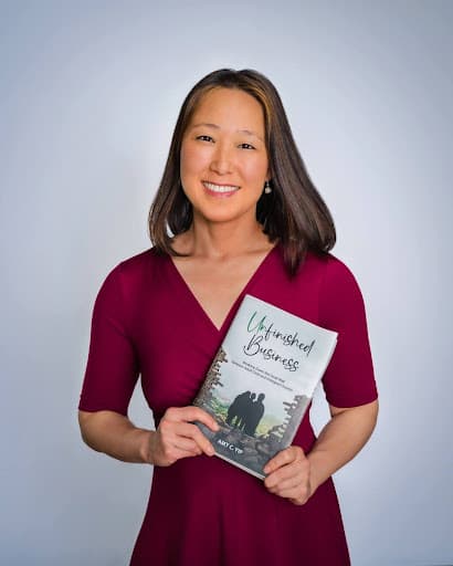 Amy Yip holding her book and posing for a photo