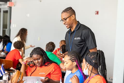 Austin Walker '11 talking with children in a classroom