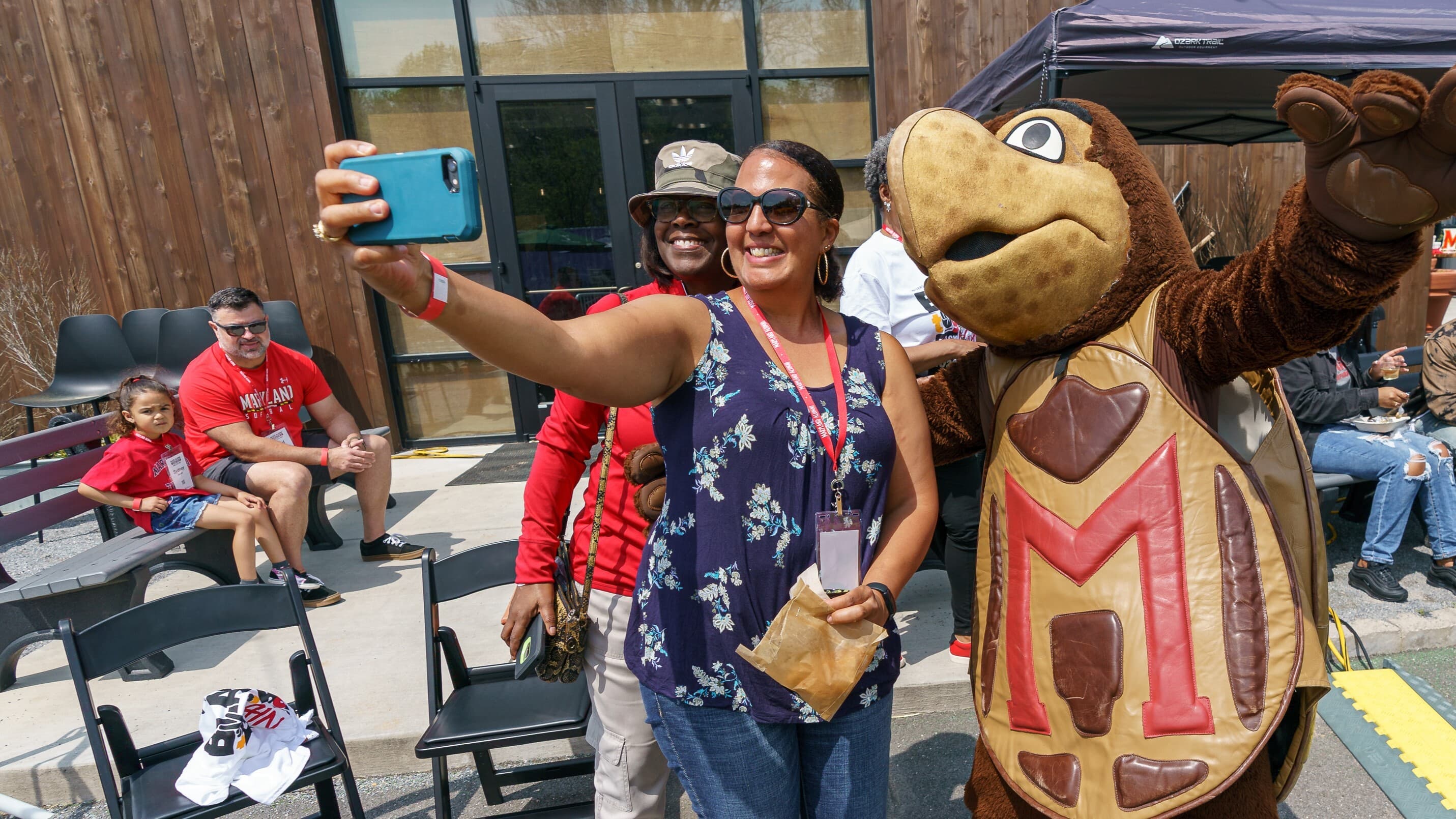 Alums taking a photo with Testudo at Terpchella