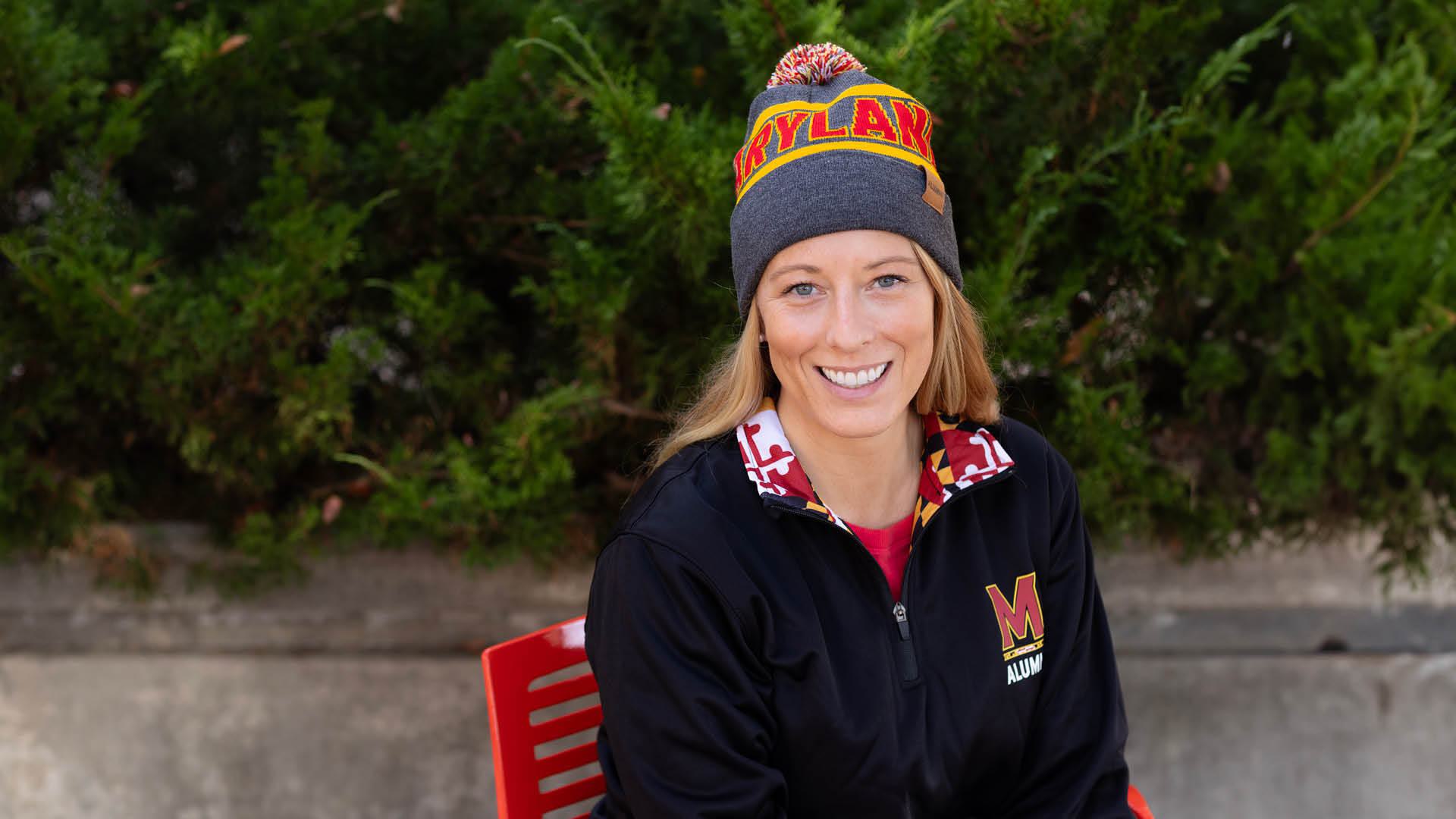 Kate Jowaisas wearing the Maryland winter beanie membership gift as well as the lifetime member pullover