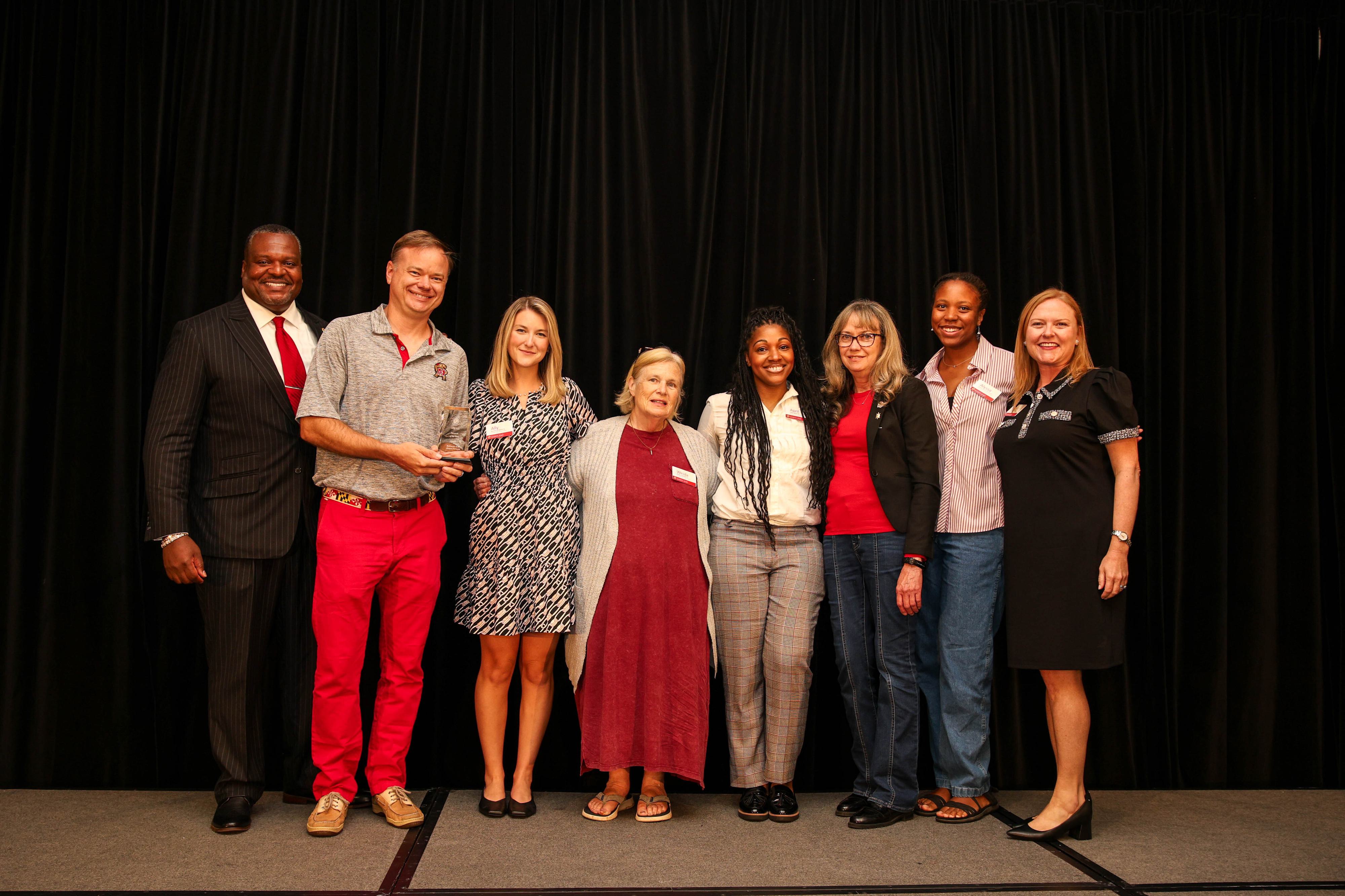 Members of the Baltimore Terps Alumni Network board pose with Bert Williams and Jessica Roberts