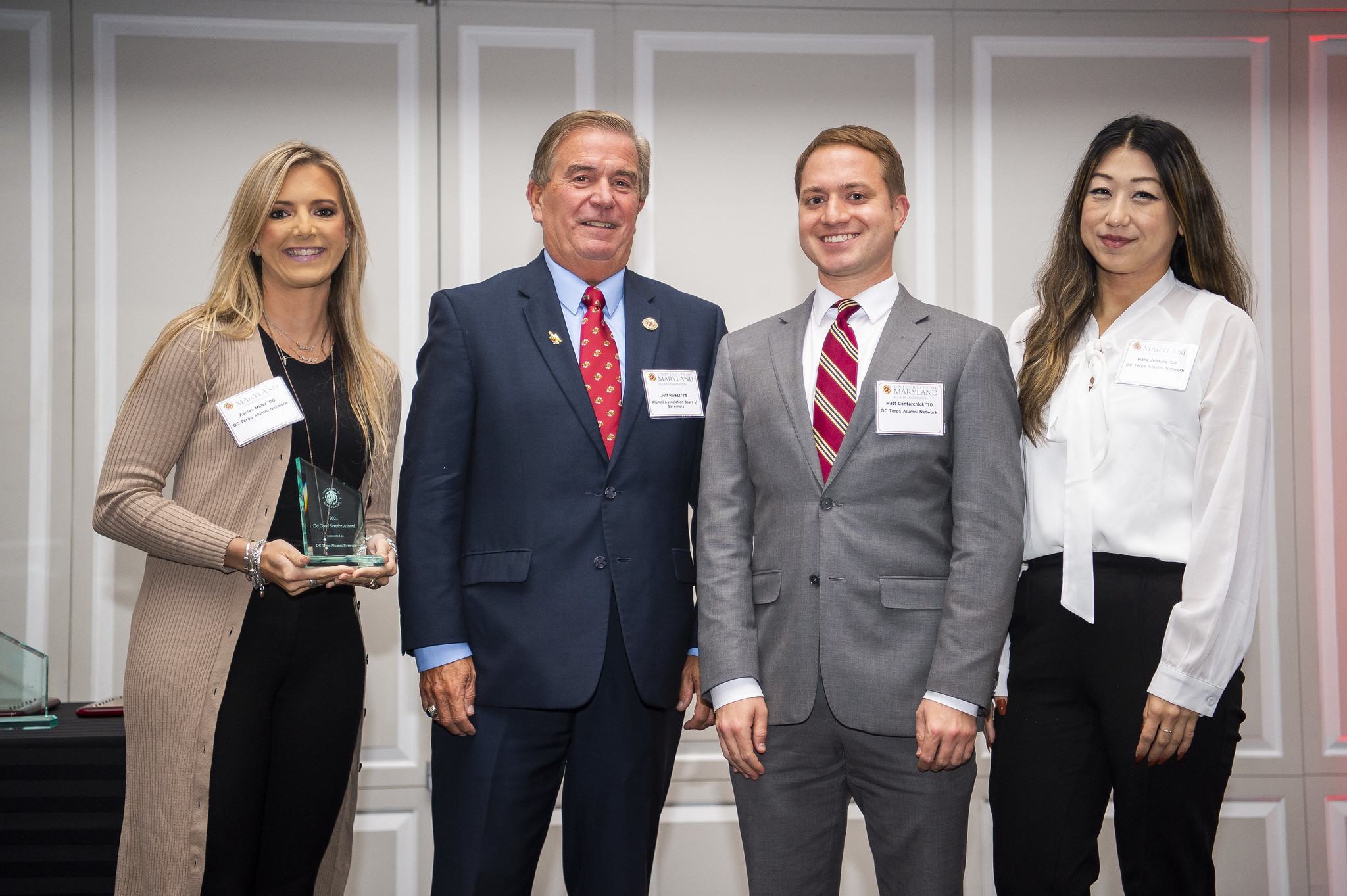 Group standing together on stage after receiving an award