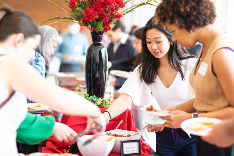 Attendees, plates in hand, deciding on the most delicious offerings at an event buffet