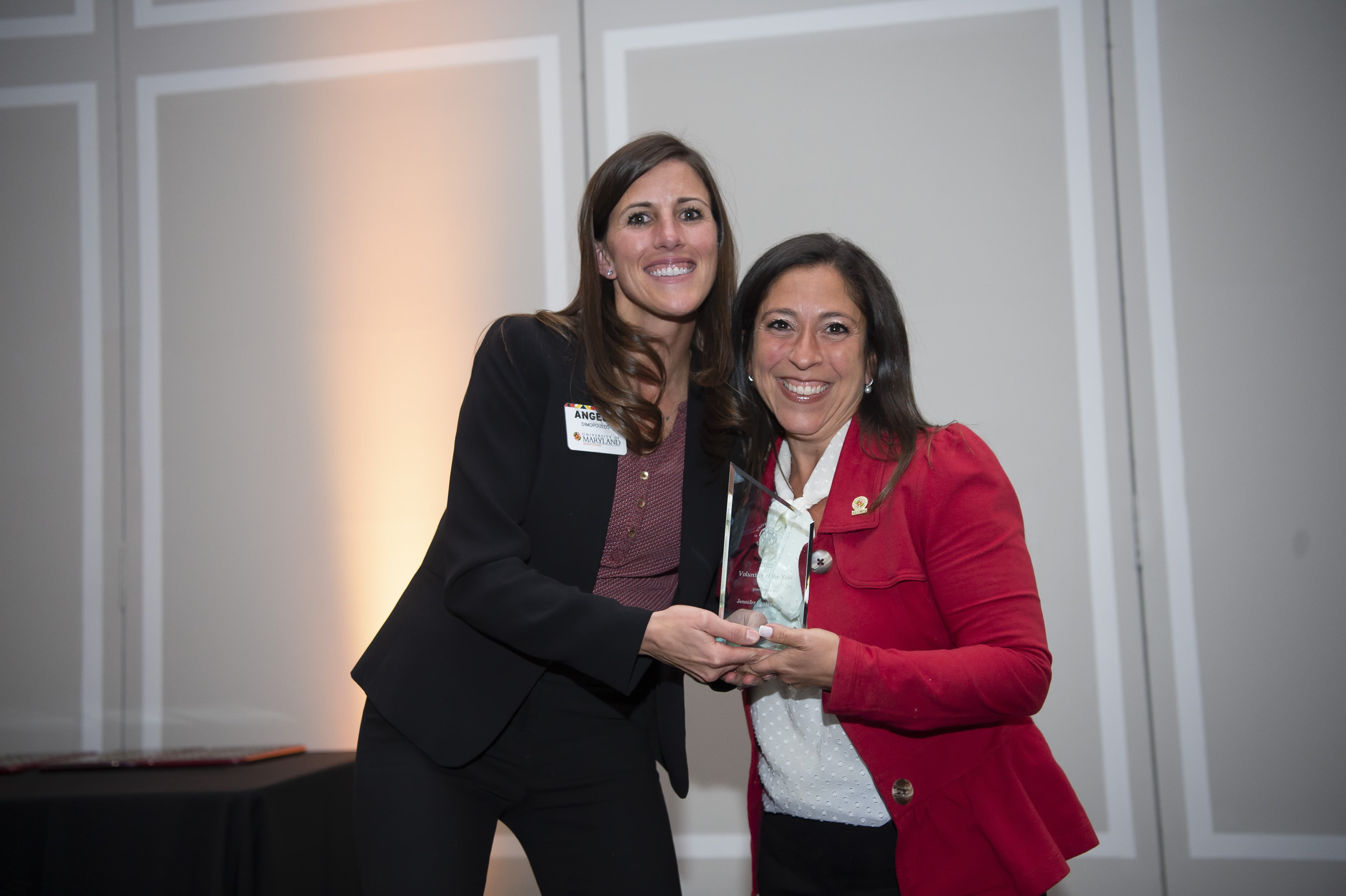 Pictured is Angela Dimopolous (left) and Jennifer Coatsworth (right), as Coatsworth receives the Volunteer of the Year Award at the 2022 UMDAA Volunteer Leadership Awards