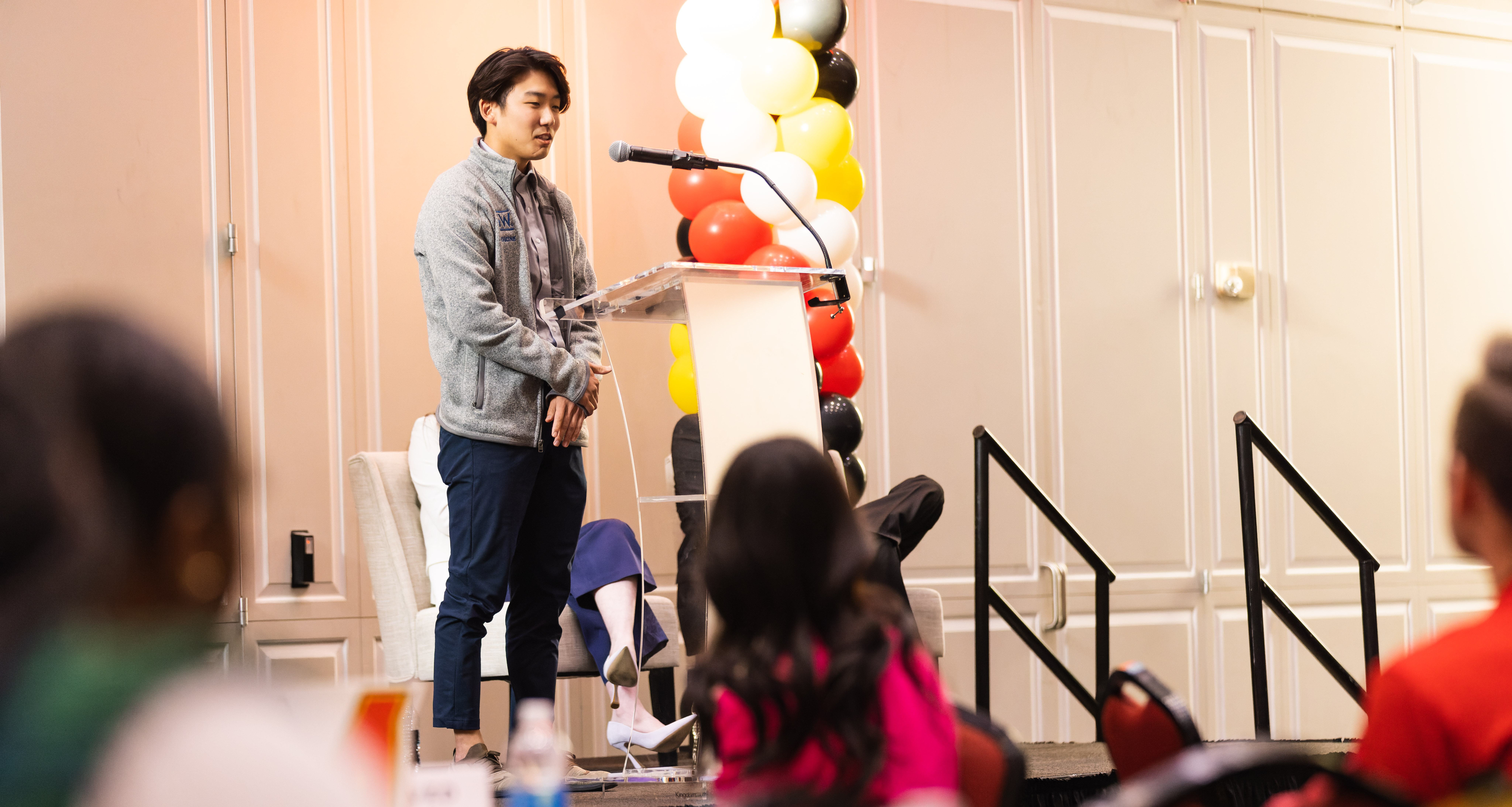 Thomas Hong '20 speaking in front of a full room of Terps Under 30 participants