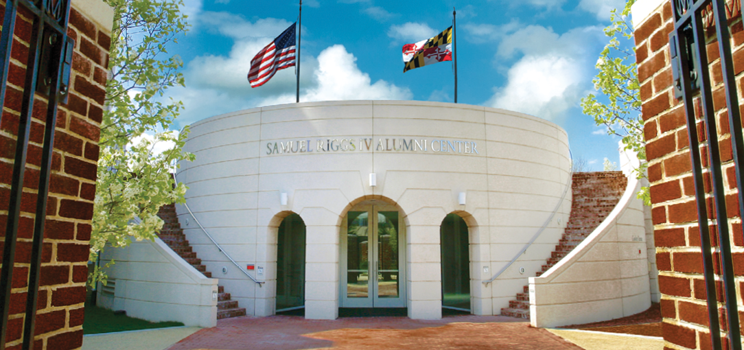 View of Front of Riggs Alumni Center from the gates of Moxley Gardens.