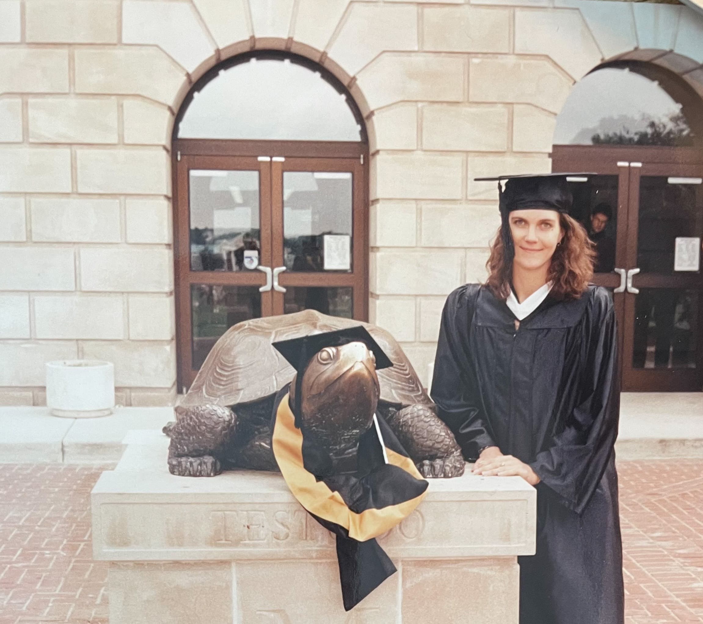Alissa Arford '94, MBA '10 posed with Testudo at her first UMD graduation in May 1994.