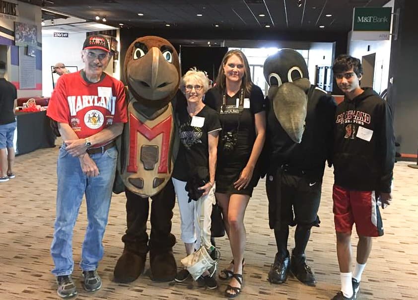 James Arford '68; Testudo; Cheryl Arford; Alissa Arford '94, MBA '10; Poe, mascot for the Baltimore Ravens, and Ryan Leyl '24 attended an alumni networking event at Raven's Stadium in 2017.