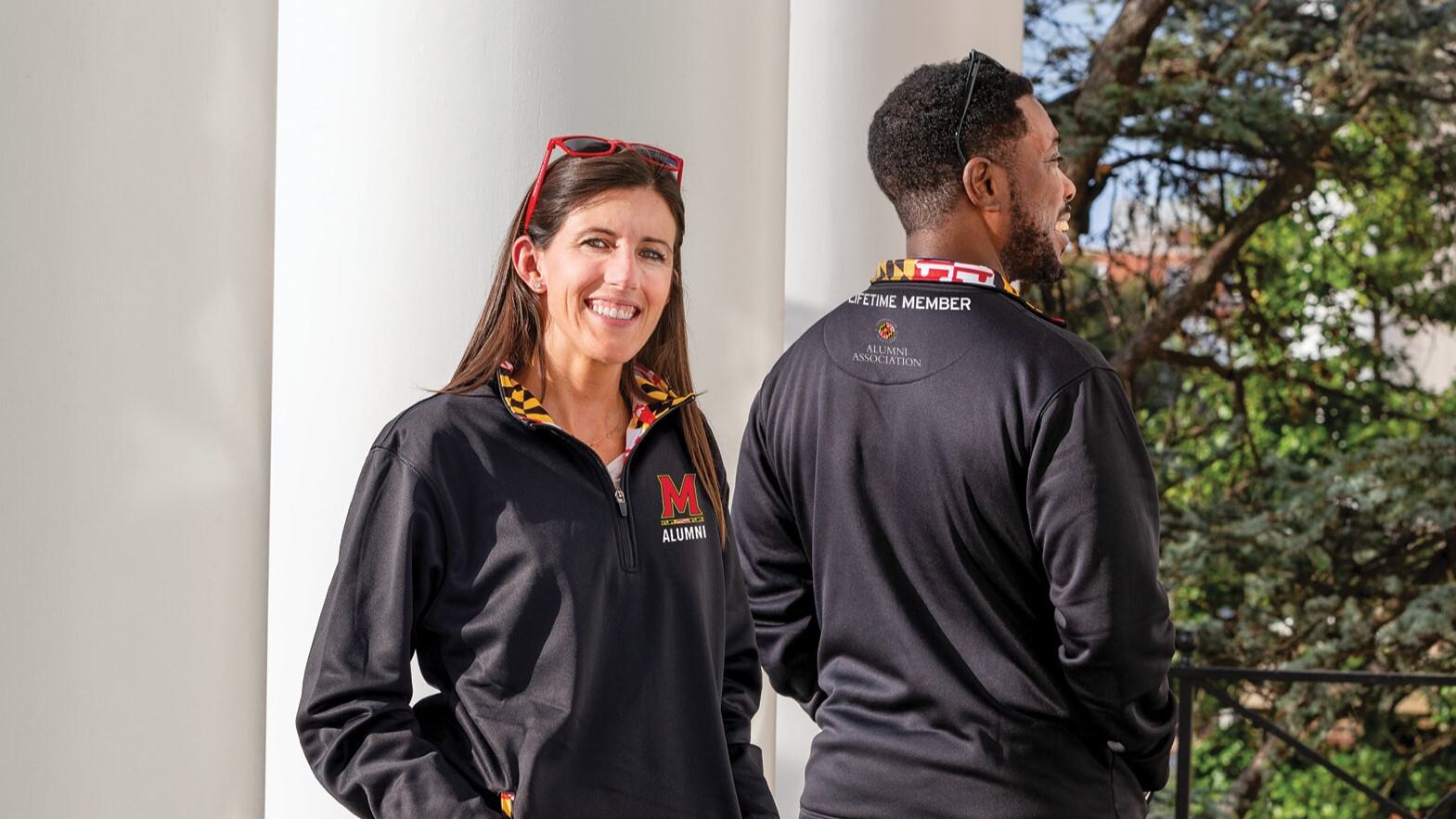 Angela Dimopoulos '07 and Wendell Ayivie '16 wearing the lifetime member pullover.