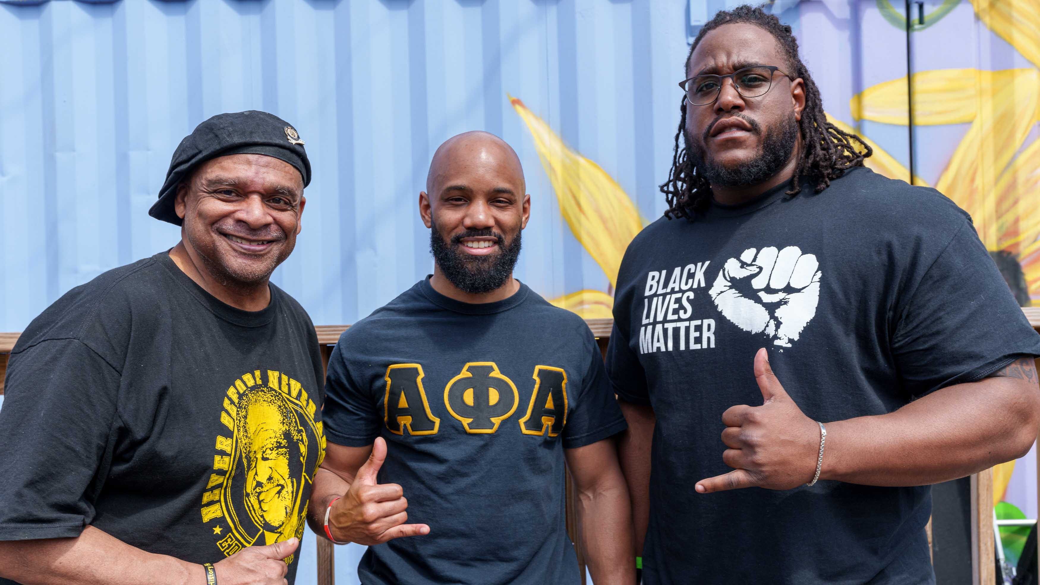 Three alums pose for a photo at one of the events part of the inaugural Black Alumni Weekend in 2022