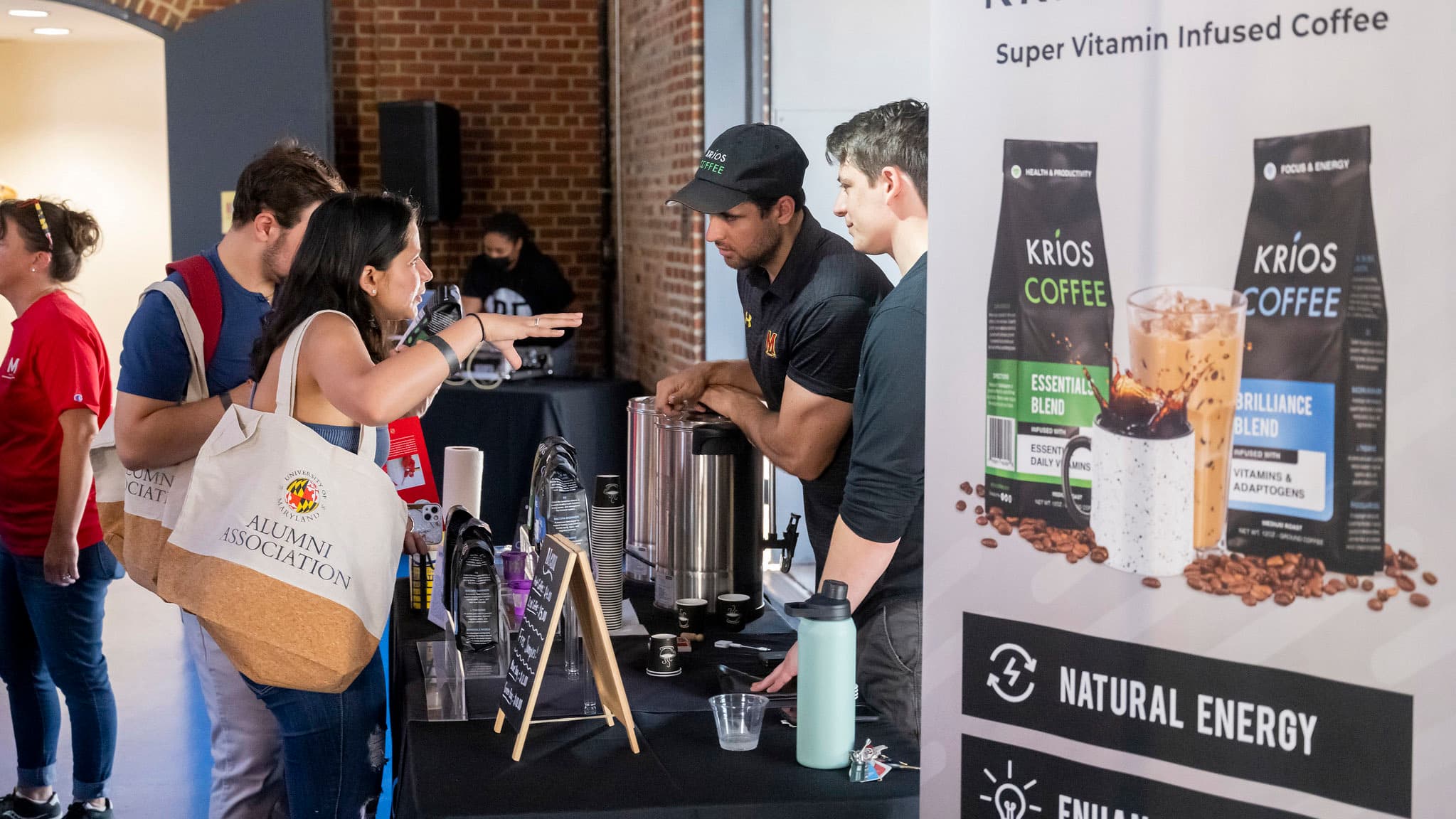 Attendee of the 2022 Terrapin Tastefest in Baltimore talks to Krios Coffee, a Terp-owned business