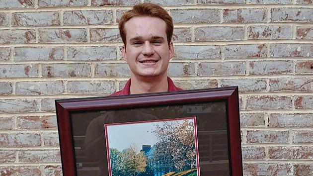 Patrick Edwards holding a diploma