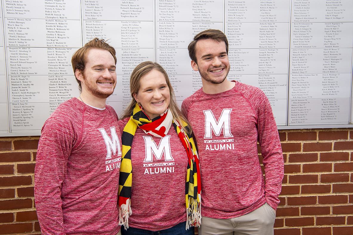 Lifetime members Patrick, Katie and Matt Edwards in front of the Frann. G & Eric S. Francis Lifetime Member Wall