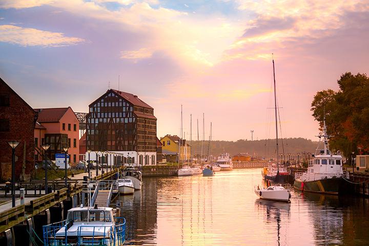 View of Klaipeda Lithuania. Boats in the river with a view of the beautiful sky and the city.