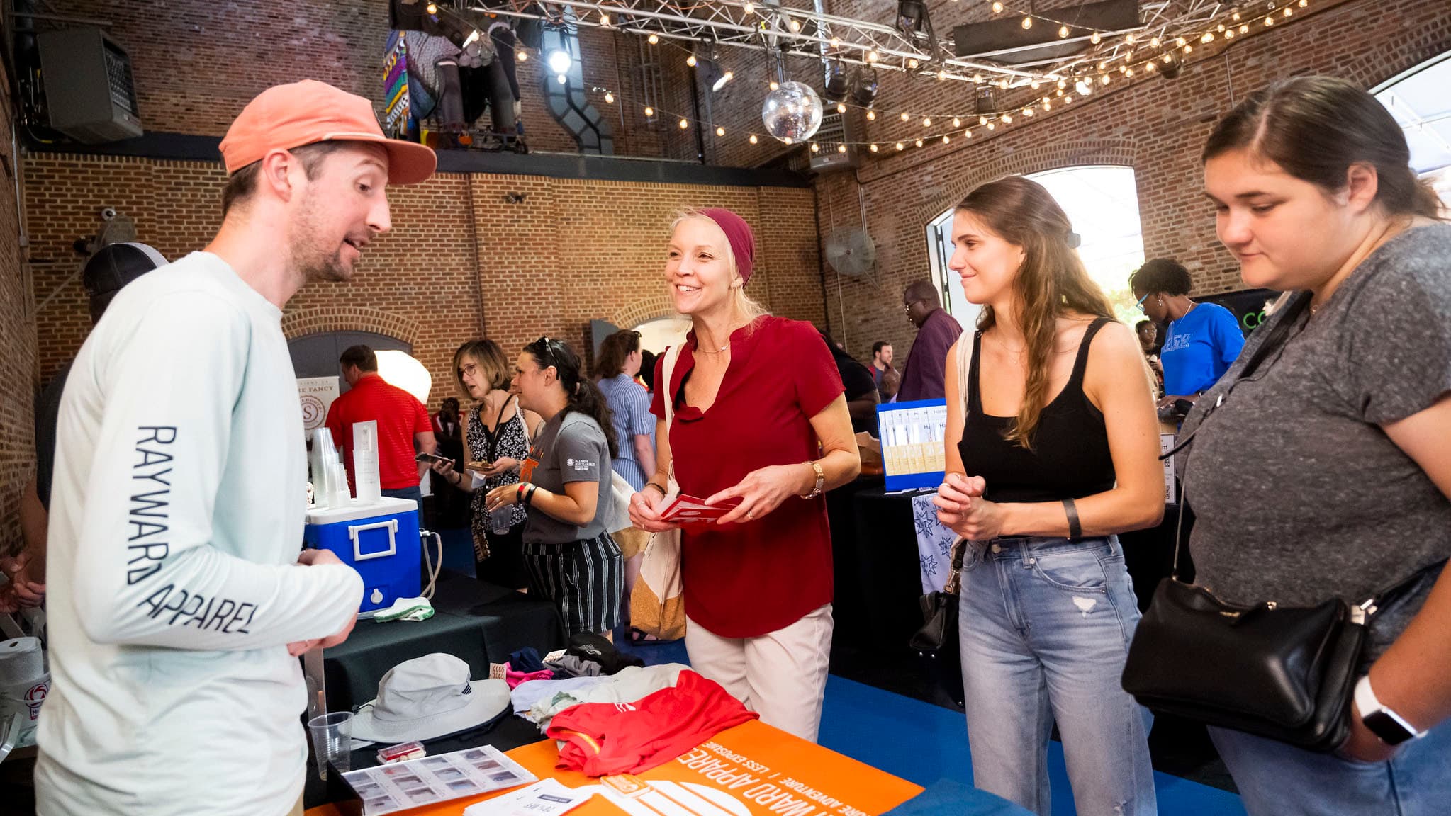 Devin Regan, founder of Rayward Apparel, speaks to visitors of his table at the 2022 Terrapin Tastefest in Baltimore.