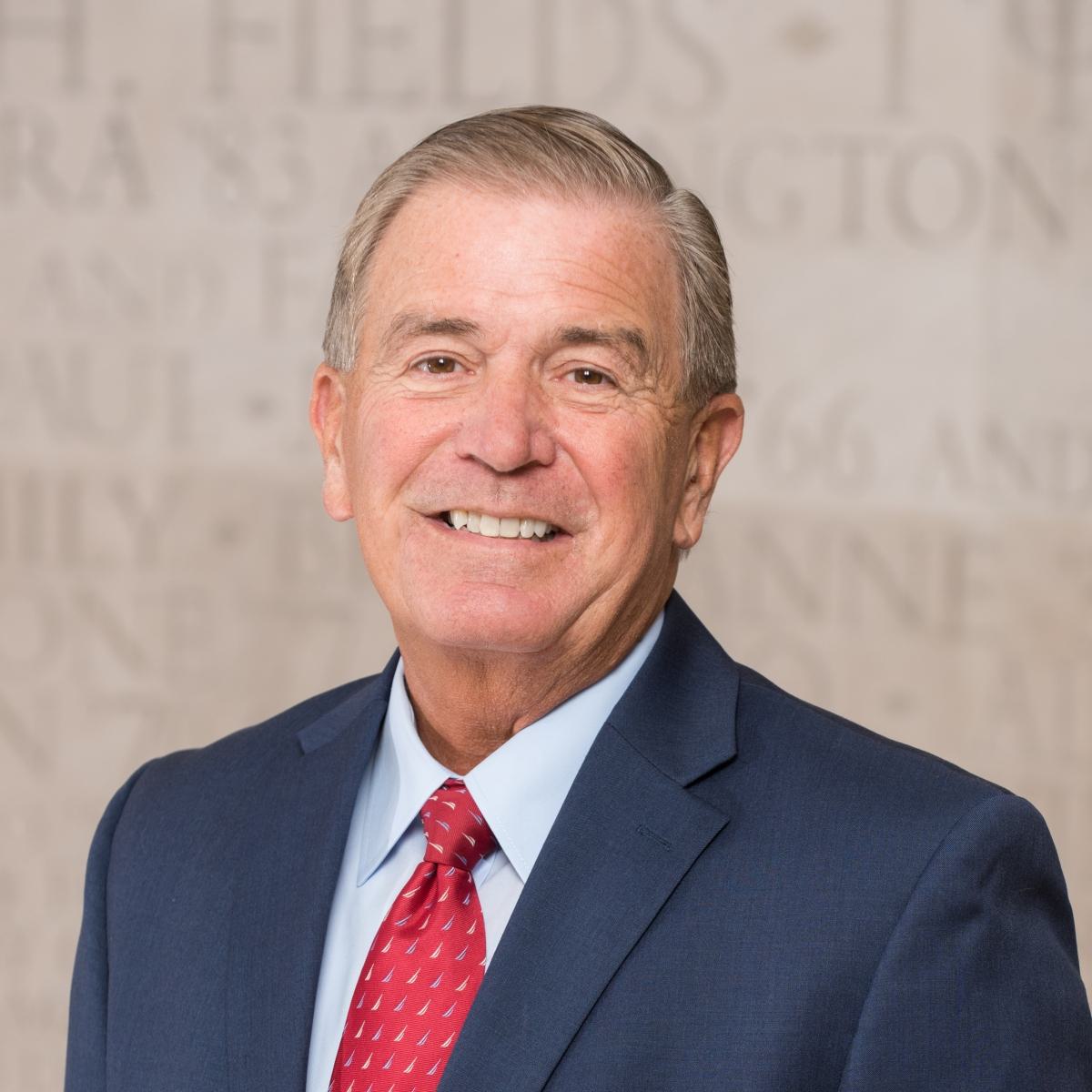 Formal portrait of Rivest Jeff in a dark suit and red tie.