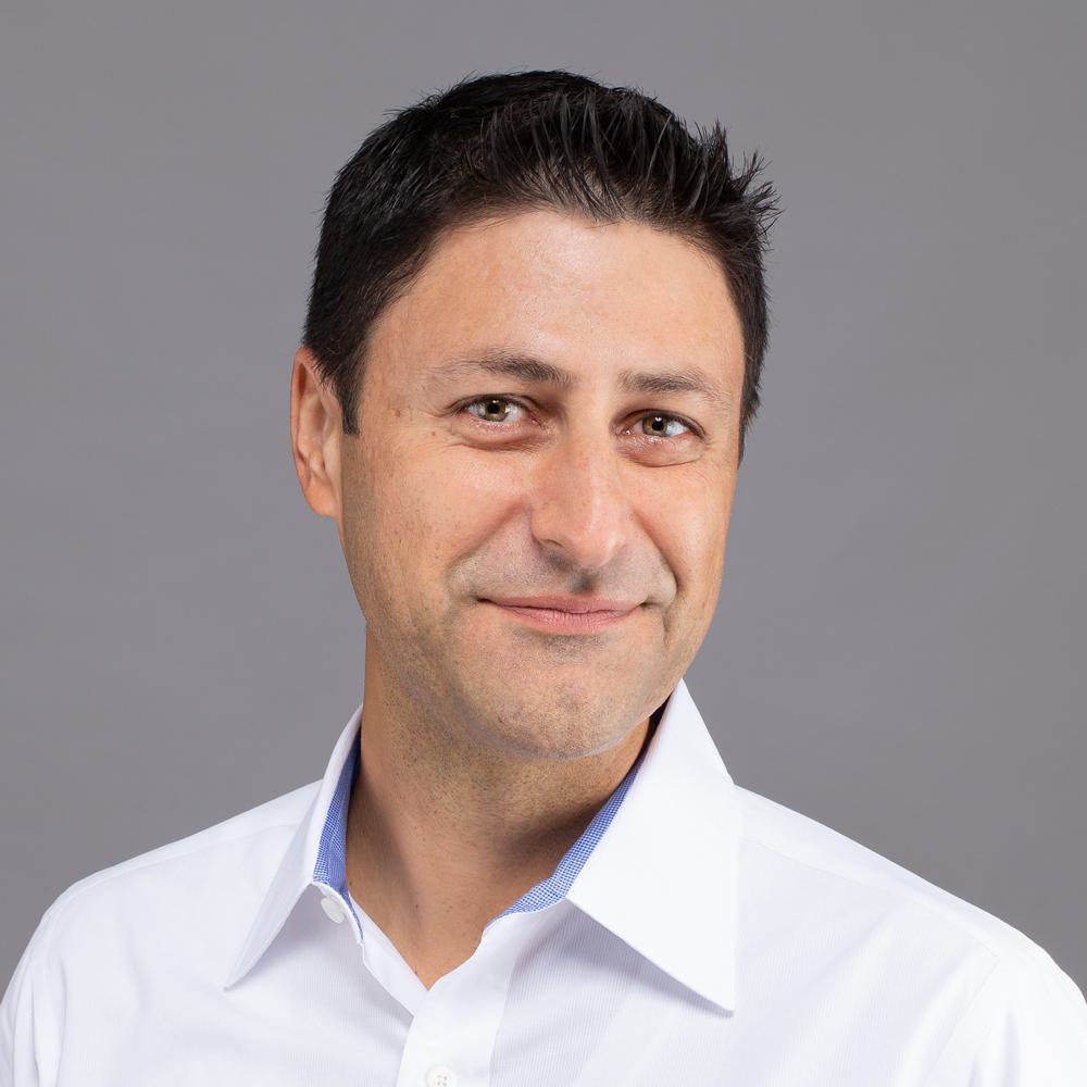 A professional headshot of Shayan Zadeh.