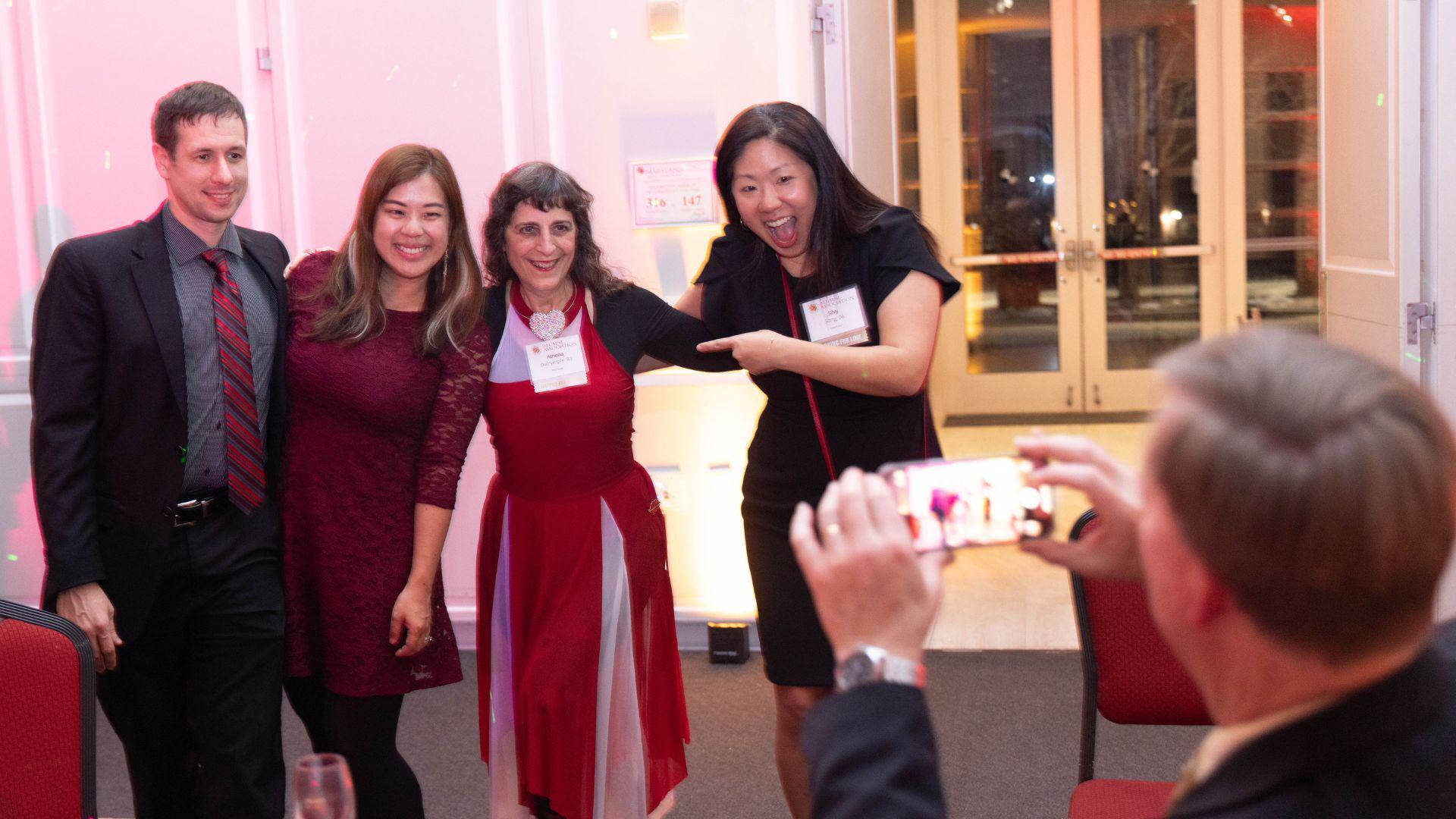 Alums pose for photo at Valentine's Dance
