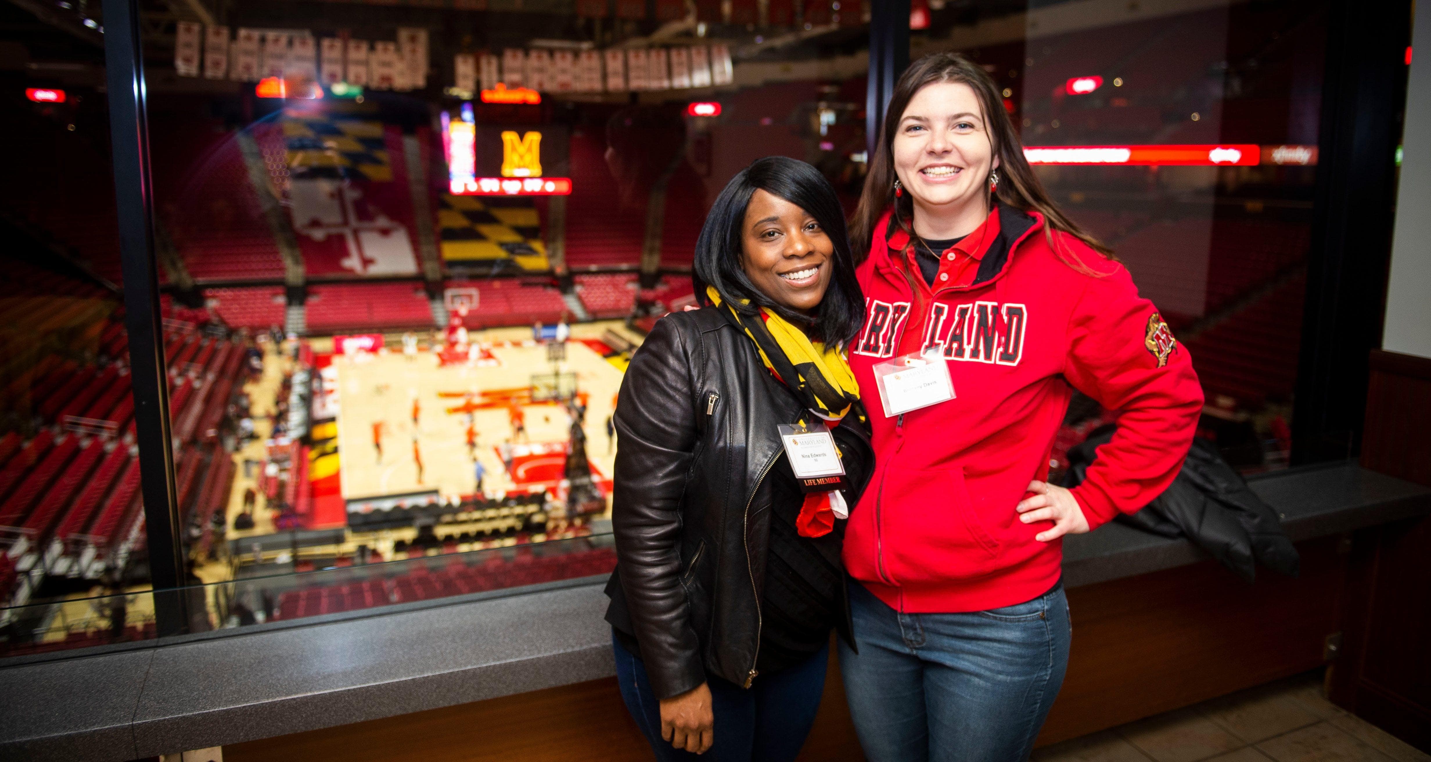 Alums overlooking the basketball court in Xfinity Center