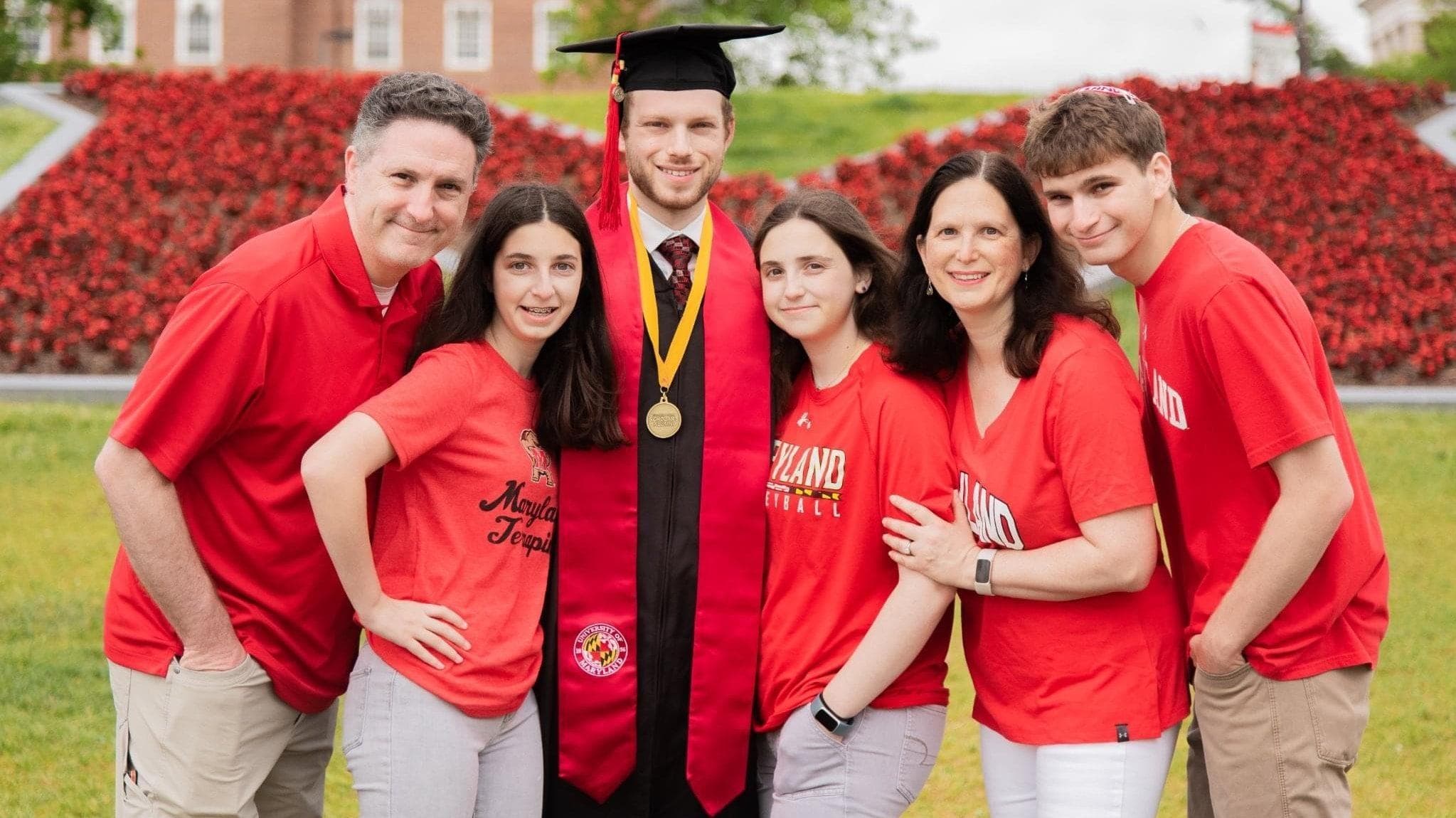Terp couple Melissa and Mark Arking posing with their four kids