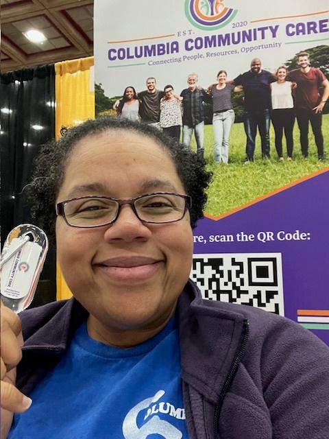 Jessica Nichols in front of a Columbia community care sign.