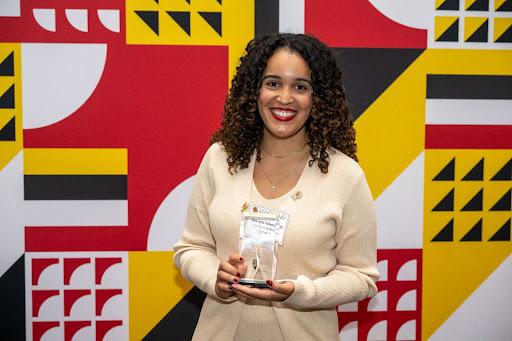 Drisneidi Villaman ’15 posing with her award